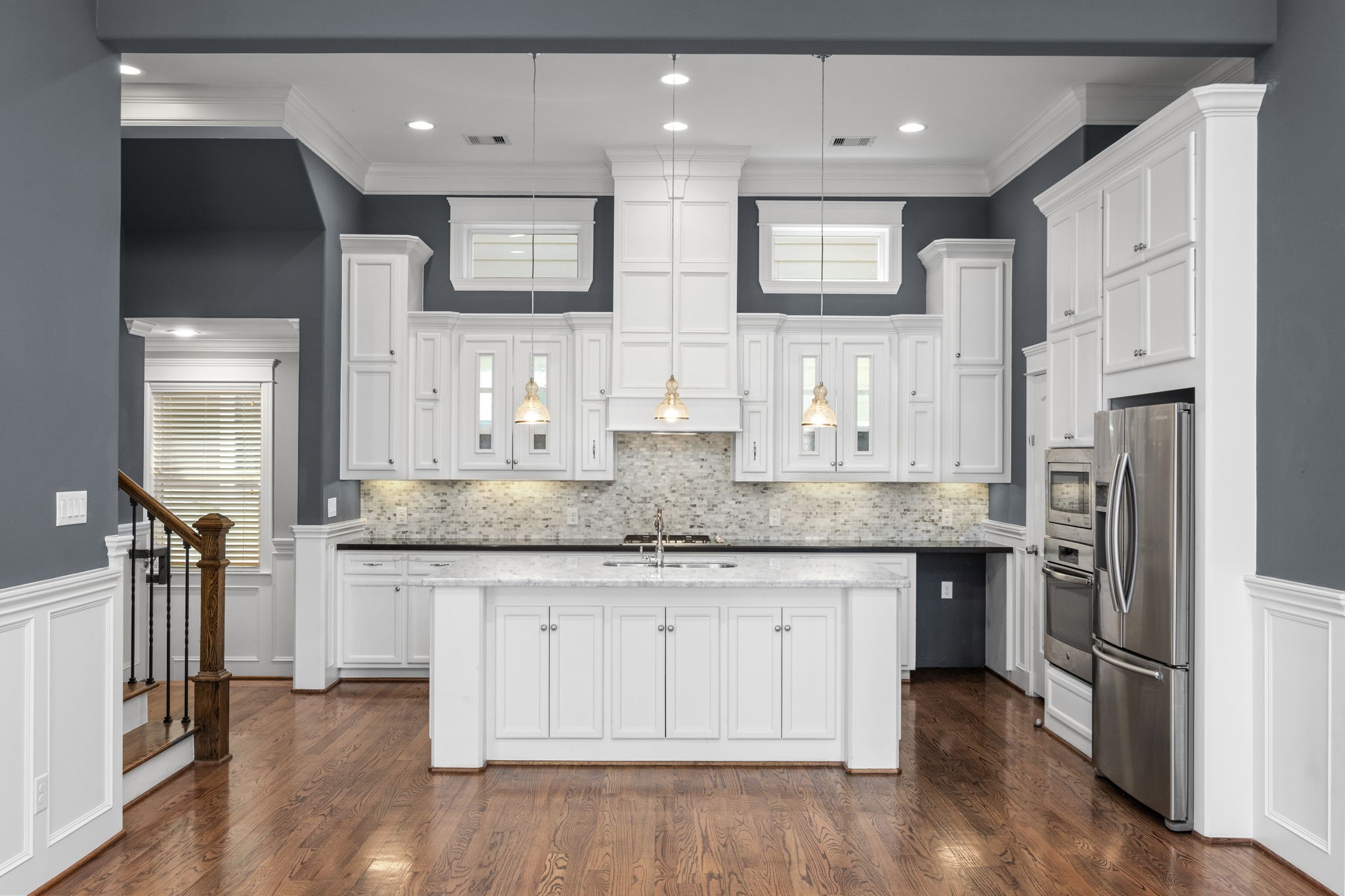 619 Rutland Street, Unit B Houston, TX 77007 - Photo 11 of 33 a kitchen with stainless steel appliances granite countertop a kitchen island hardwood floor and a sink