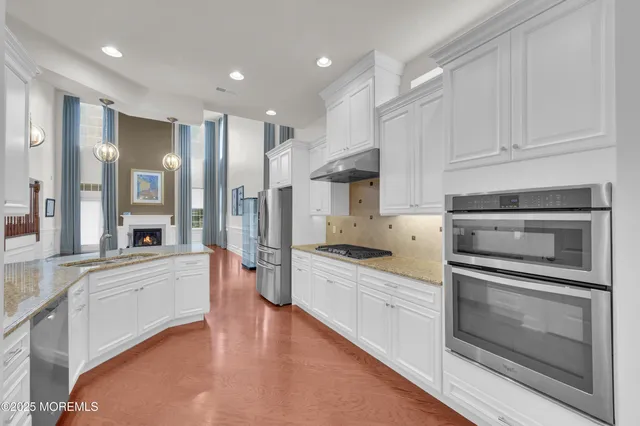a large kitchen with a stove top oven