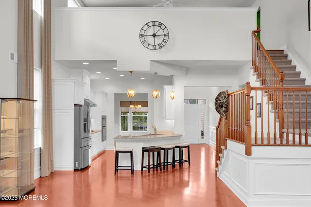 a dining room with wooden floor and a chandelier