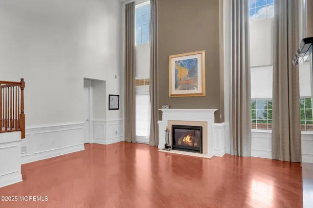 a view of an empty room with window and fire place