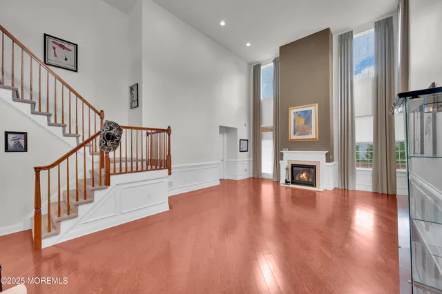 a view of a livingroom with wooden floor and a fireplace