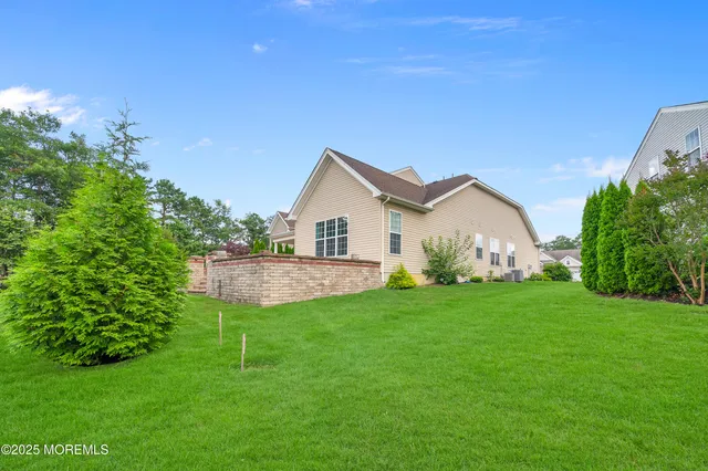 an aerial view of residential houses with outdoor space and trees all around