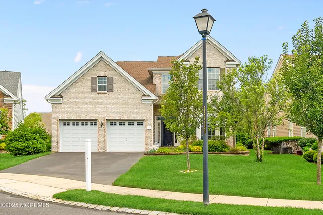 an aerial view of residential houses with outdoor space and ocean view
