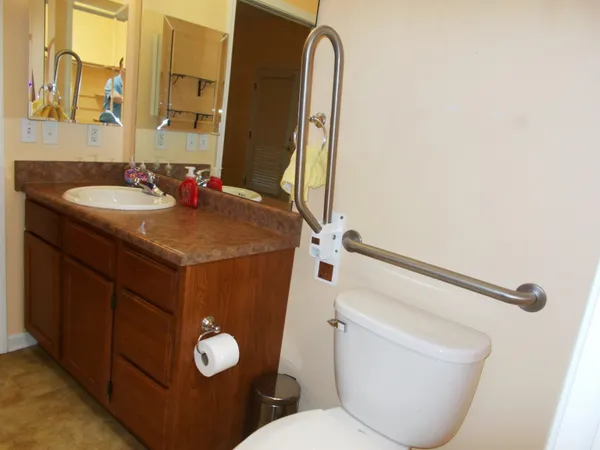 a bathroom with a toilet sink and mirror