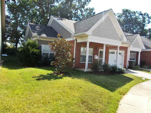 a view of a house with garden and backyard