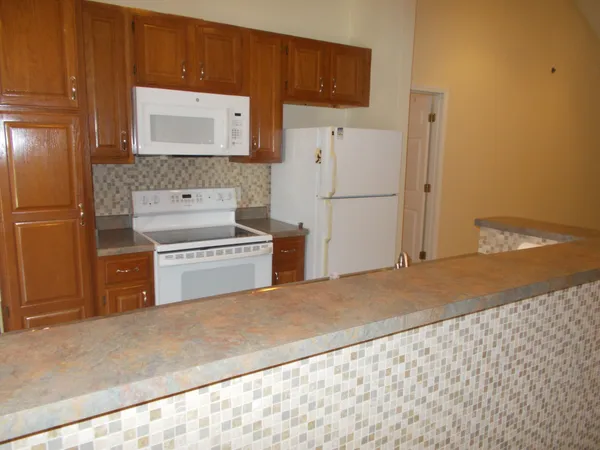 a kitchen with a refrigerator sink and stove