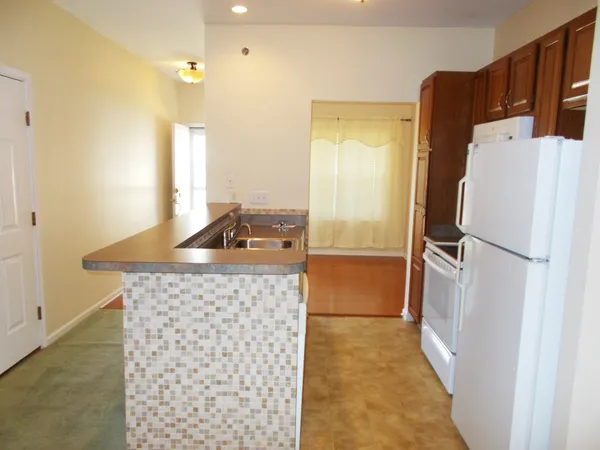 a kitchen with a refrigerator and a stove