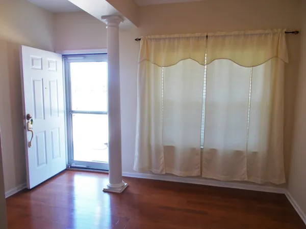 a view of a room with wooden floor and a window