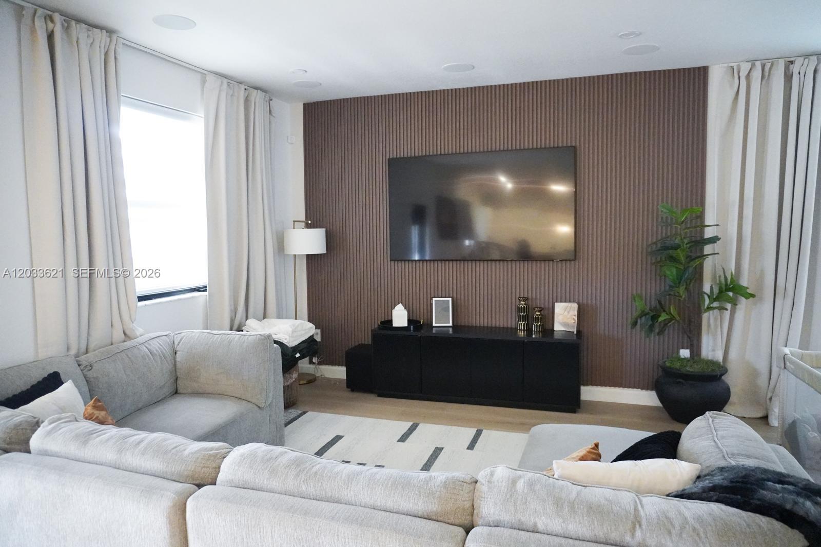 11942 Southwest 243rd Street Homestead, FL 33032 - Photo 8 of 50 a living room with furniture and a flat screen tv