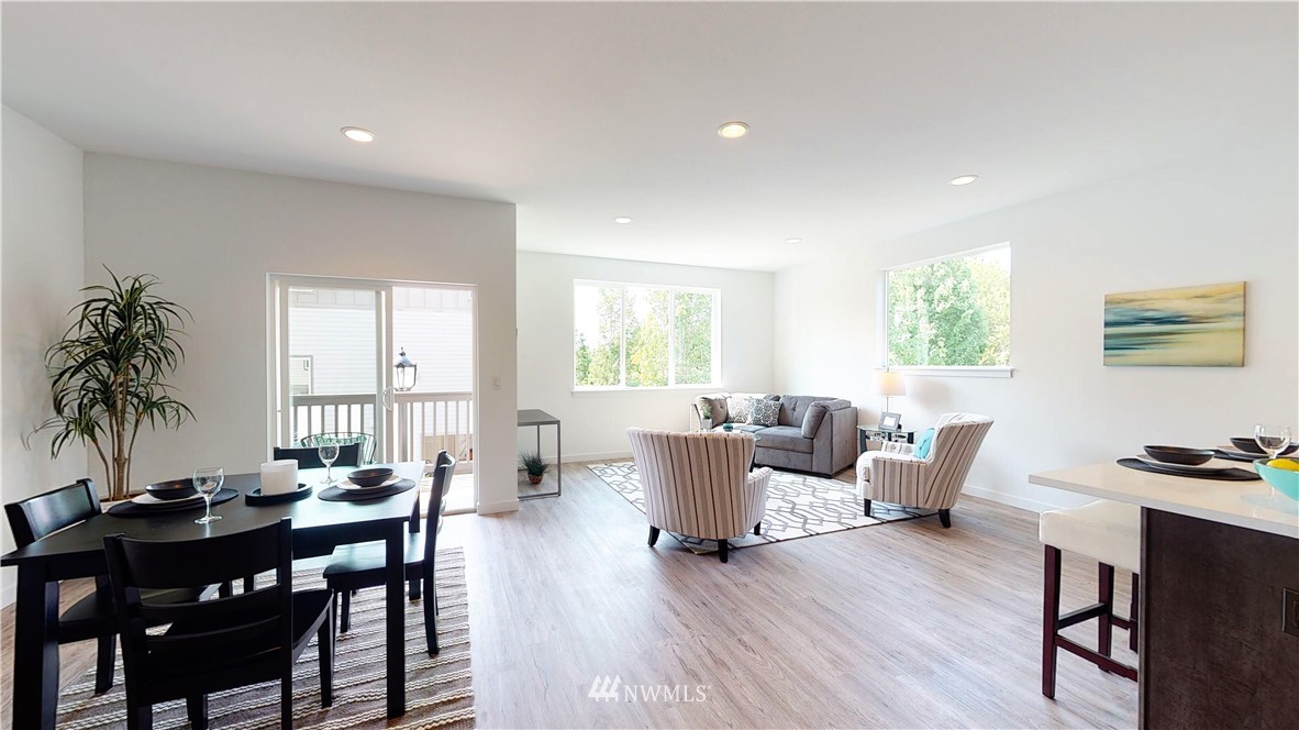 331 South 48th Court, Unit E12 Renton, WA 98055 - Photo 8 of 25 a view of a dining room with furniture window and wooden floor