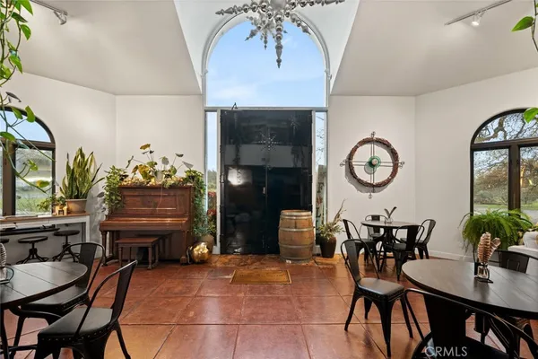 a view of a dining room with furniture and chandelier