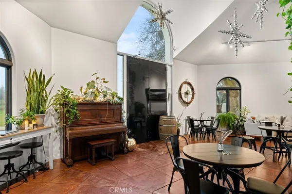a view of a dining room with furniture and chandelier
