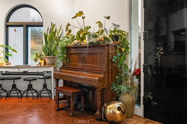 a view of a chairs and table in the back yard of the house