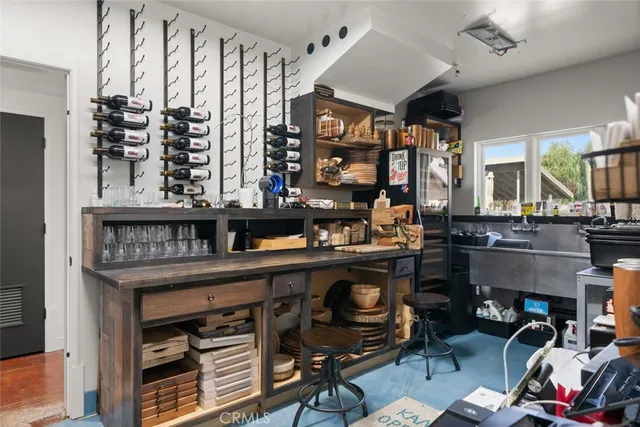 a living room with a sink and a mirror with wooden floor