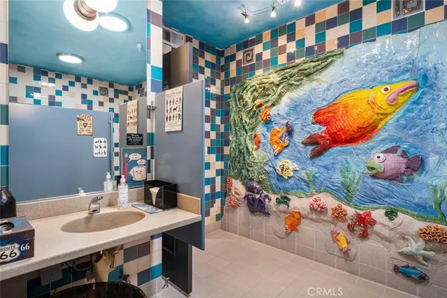 a kitchen with stainless steel appliances kitchen island granite countertop a refrigerator and a stove top oven