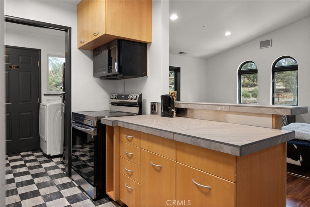 6237 Cohasset Road Chico, CA 95973 - Photo 59 of 73 a kitchen with stainless steel appliances kitchen island granite countertop a refrigerator and a stove top oven