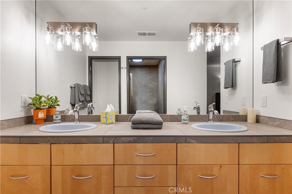 6237 Cohasset Road Chico, CA 95973 - Photo 63 of 73 a bathroom with double vanity and a mirror