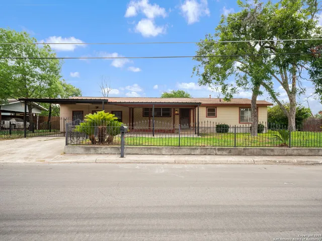 a view of a house with a garden and plants