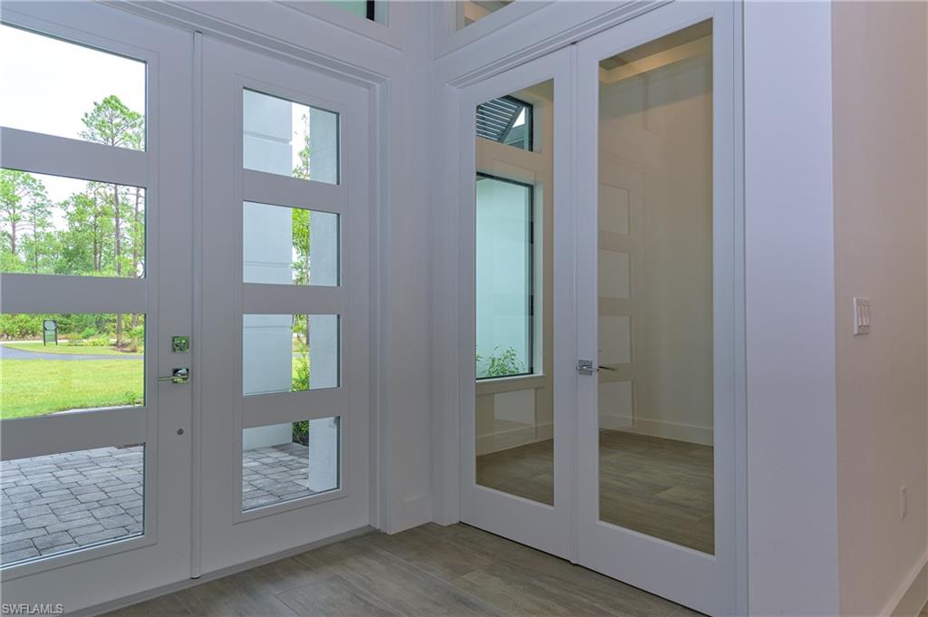 98 9th Street Southwest Naples, FL 34117 - Photo 5 of 27 Den with glass French doors