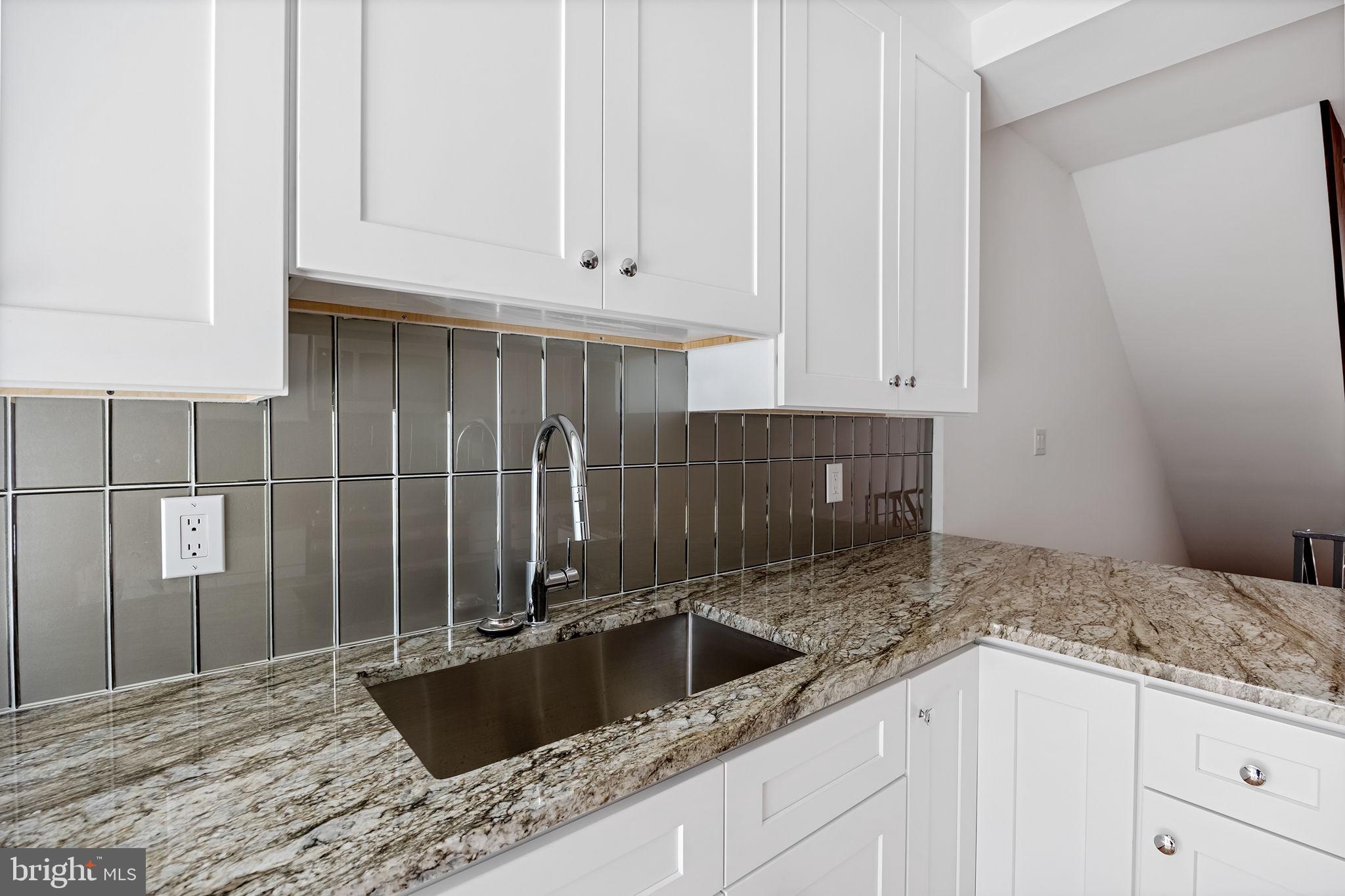811 Kimball Street Philadelphia, PA 19147 - Photo 16 of 37 a kitchen with granite countertop a sink and cabinets