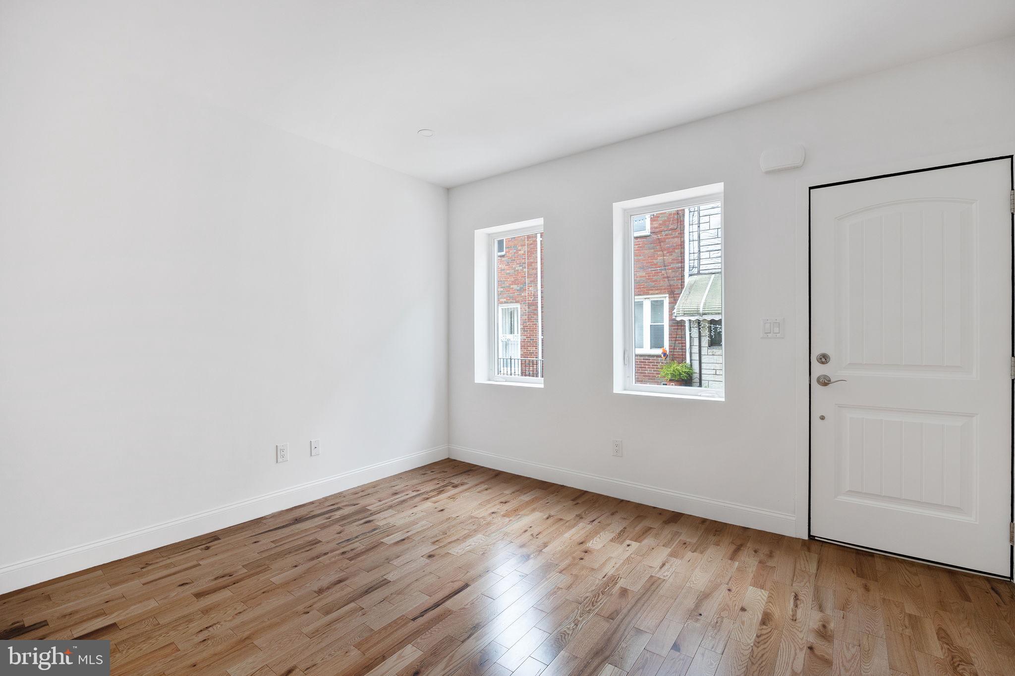 811 Kimball Street Philadelphia, PA 19147 - Photo 18 of 37 a view of an empty room with wooden floor and a window