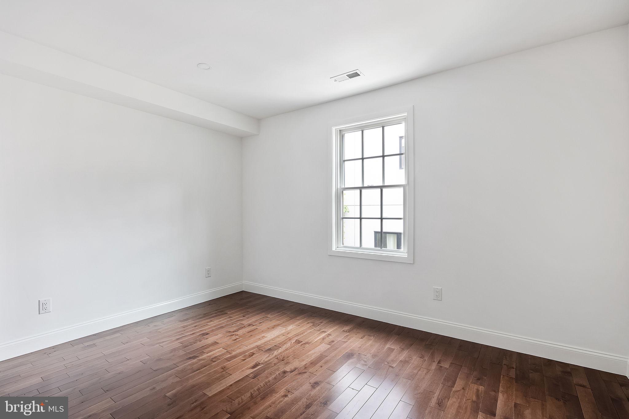 811 Kimball Street Philadelphia, PA 19147 - Photo 19 of 37 an empty room with wooden floor and windows