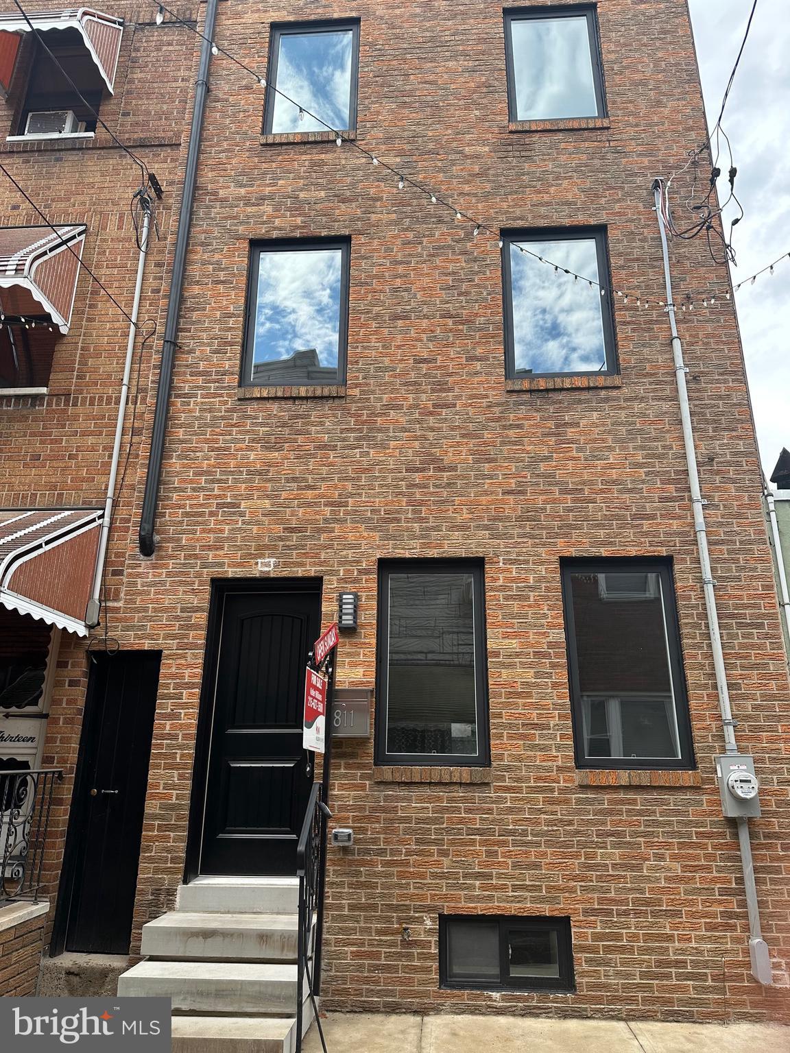 811 Kimball Street Philadelphia, PA 19147 - Photo 2 of 37 a view of a brick house with large windows