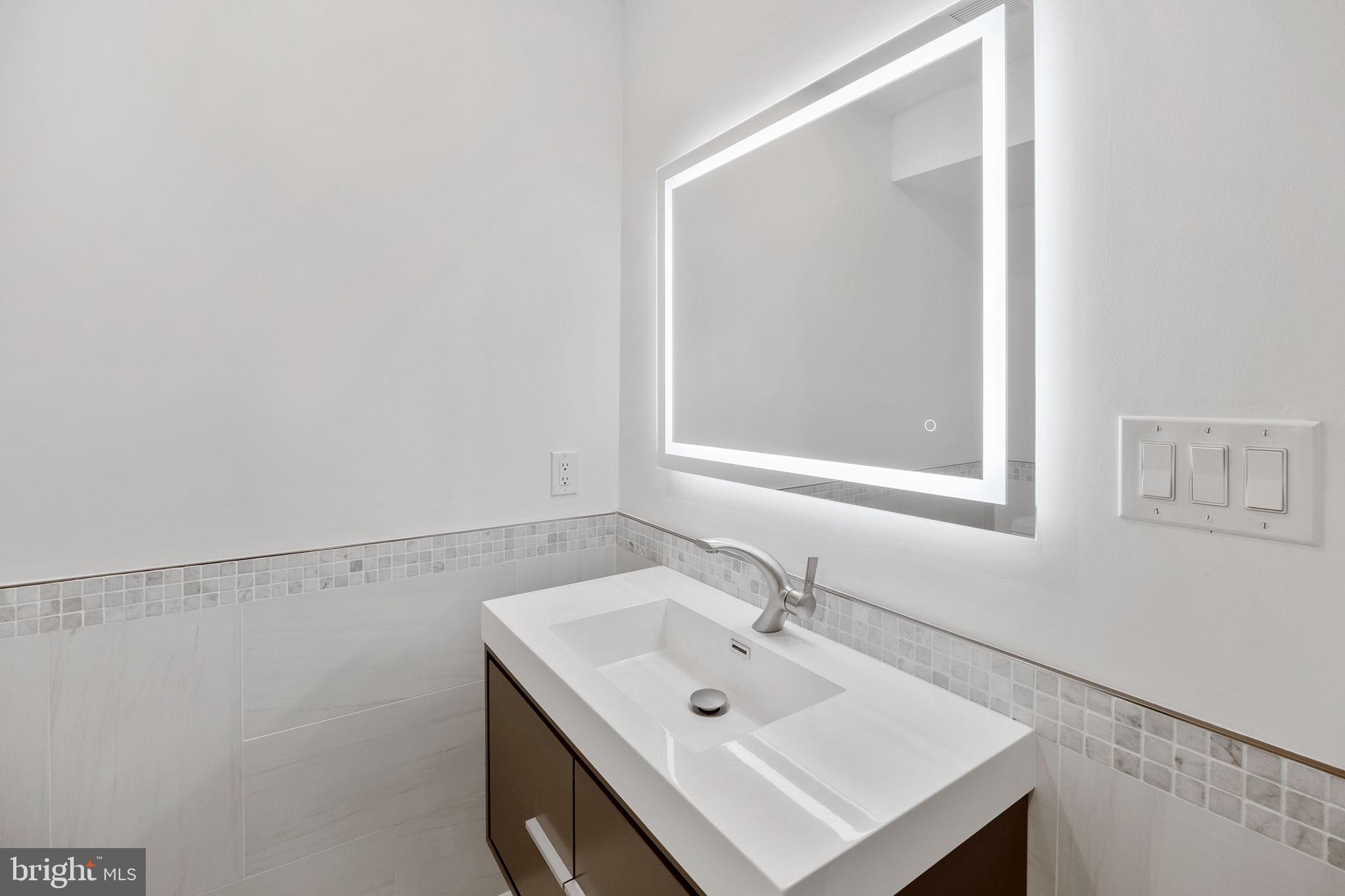 811 Kimball Street Philadelphia, PA 19147 - Photo 22 of 37 a bathroom with a sink and a mirror