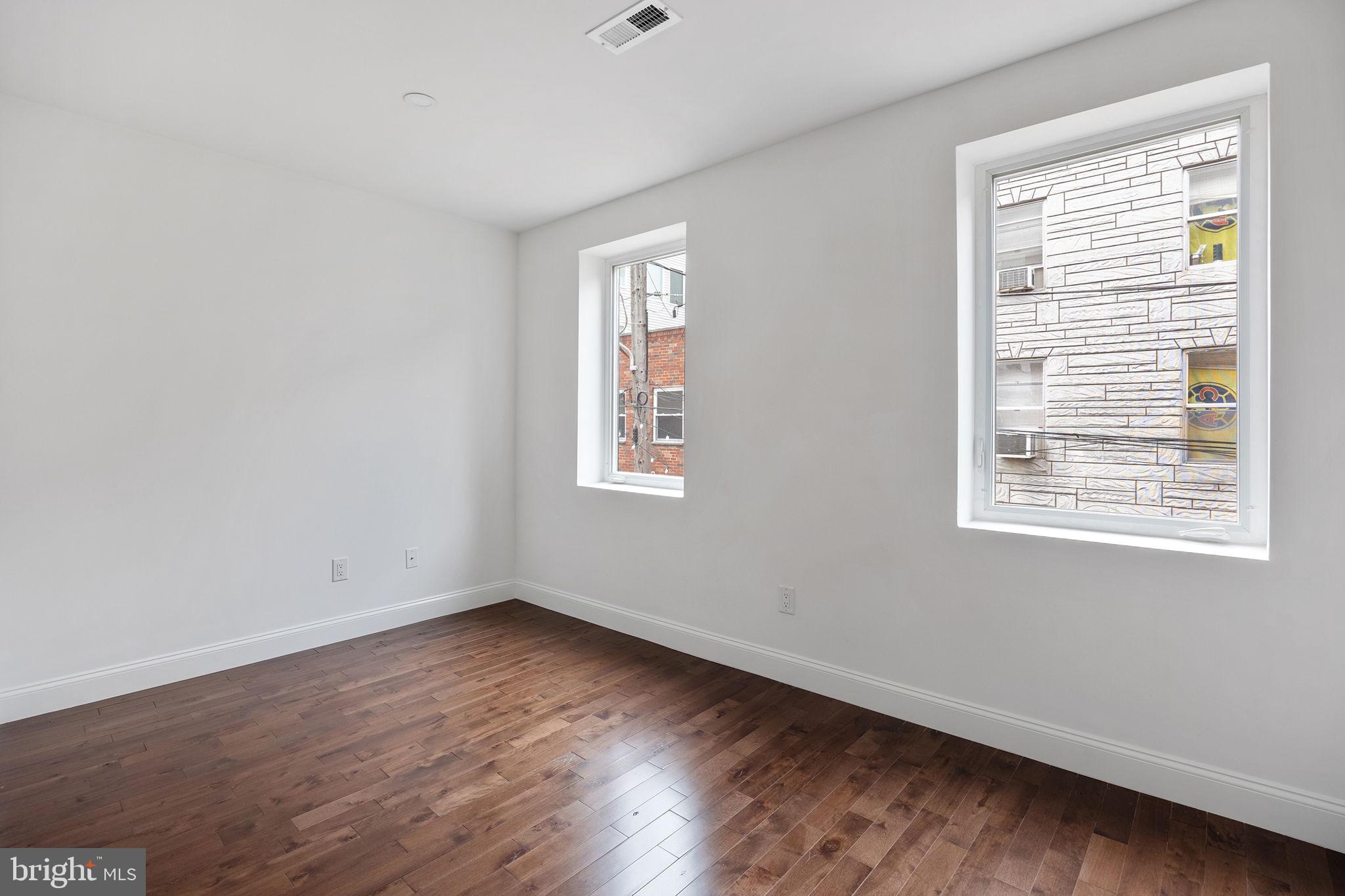 811 Kimball Street Philadelphia, PA 19147 - Photo 23 of 37 a view of an empty room with wooden floor and a window