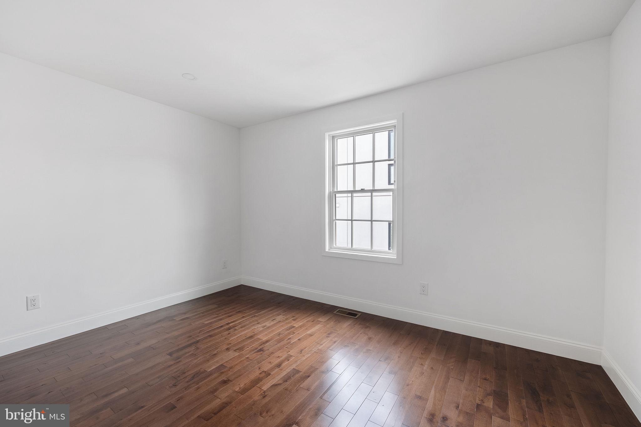 811 Kimball Street Philadelphia, PA 19147 - Photo 26 of 37 an empty room with wooden floor and windows