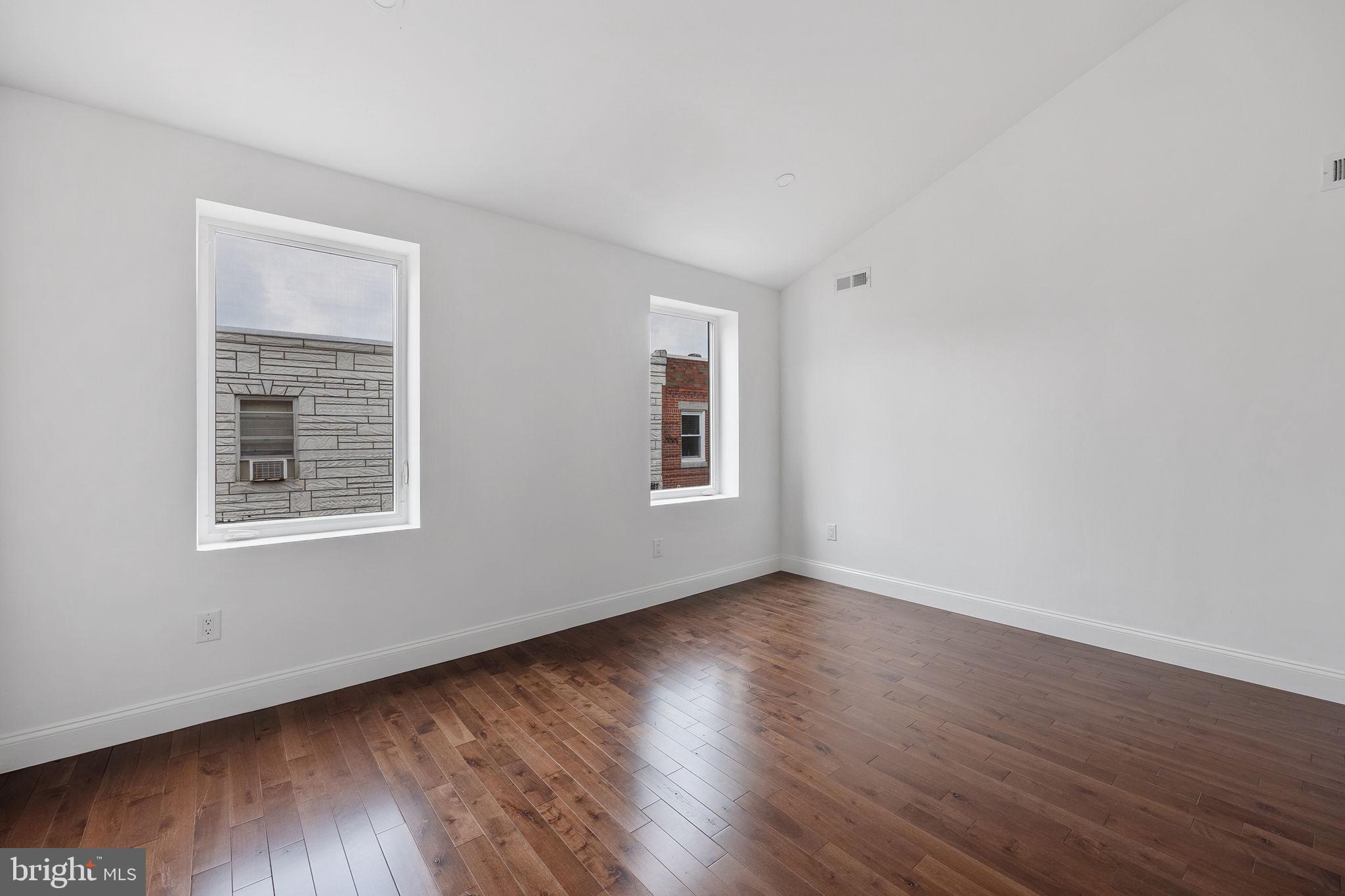 811 Kimball Street Philadelphia, PA 19147 - Photo 27 of 37 a view of an empty room with wooden floor and a window
