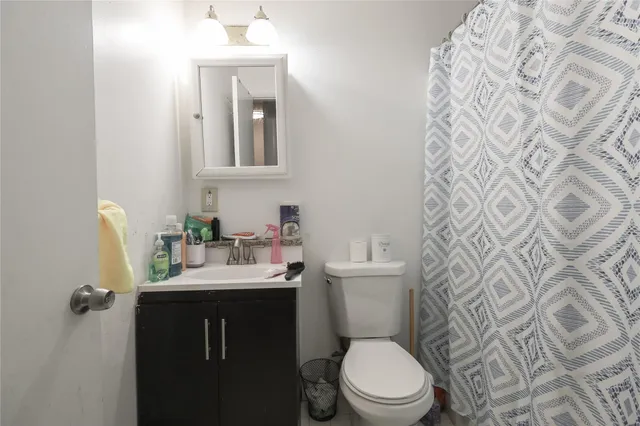 a bathroom with a sink toilet and mirror