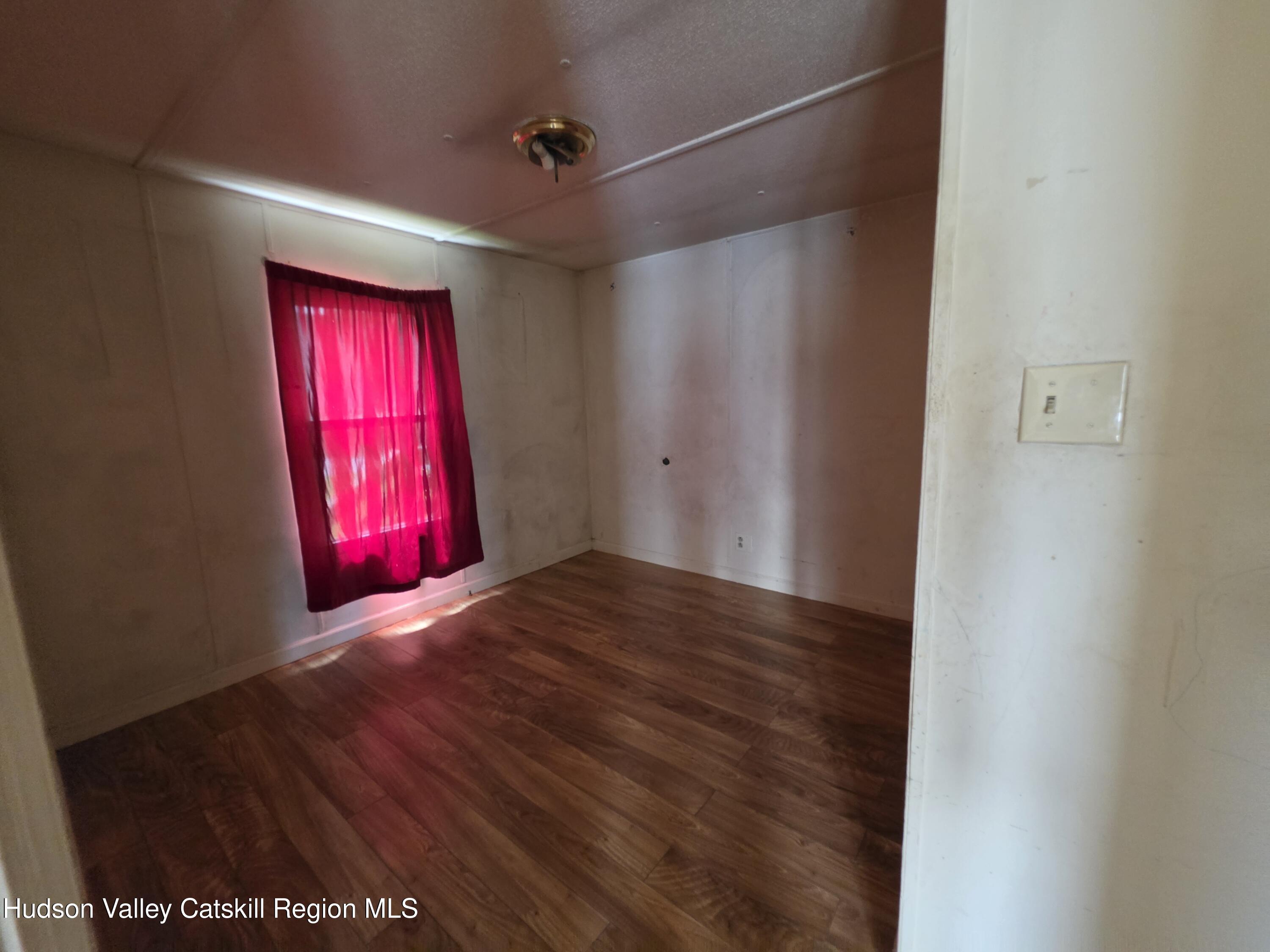852 State Rt 17B Monticello, NY 12701 - Photo 15 of 26 a view of empty room with red carpet