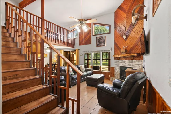 a view of staircase with furniture and a fireplace