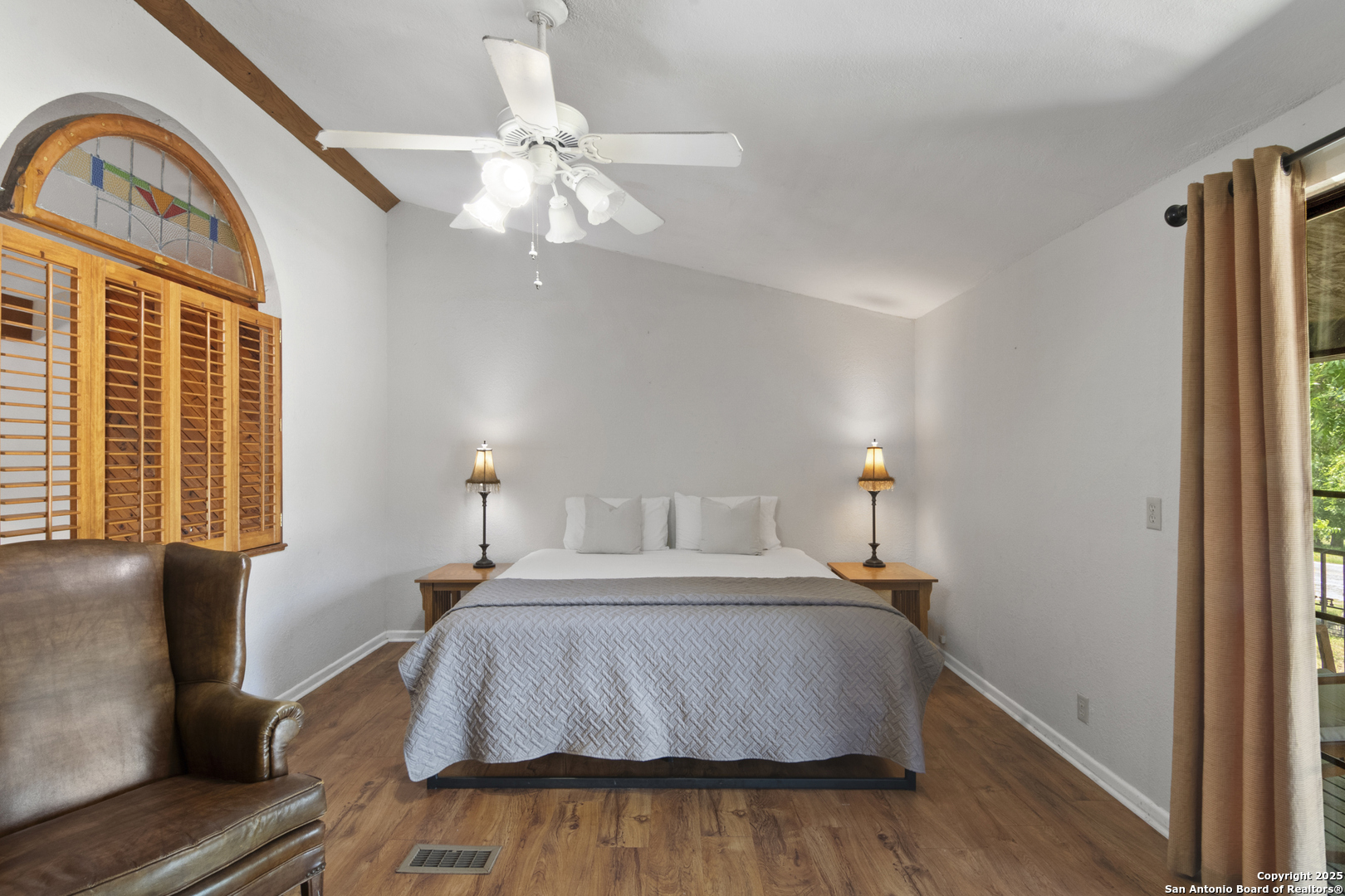 6641 Ranch Road 1120, Unit A B C D Rio Frio, TX 78879 - Photo 22 of 34 a bedroom with a bed and wooden floor