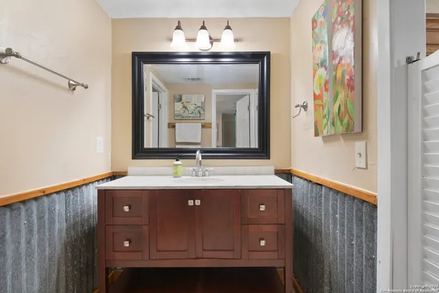 a bathroom with a sink and a mirror