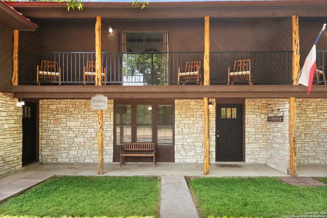 a view of a porch with a door and a yard