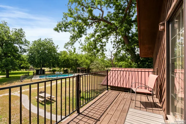 a view of balcony with wooden floor and fence