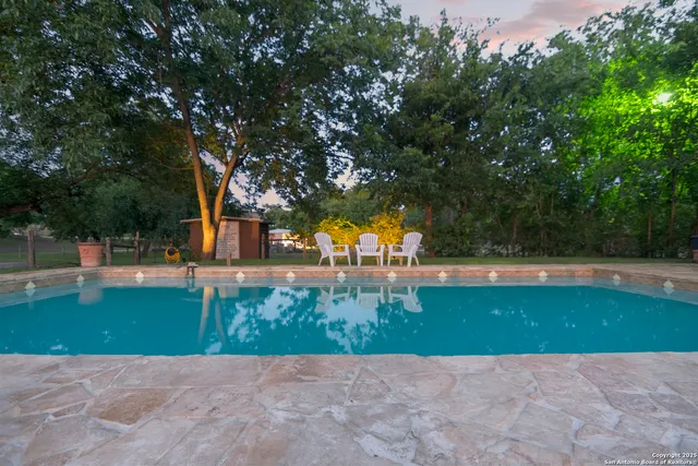 a view of swimming pool with a garden