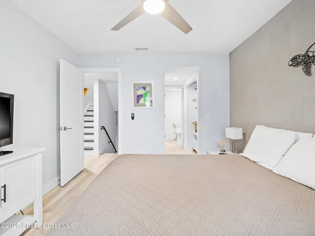 a bedroom with a bed and a flat tv screen