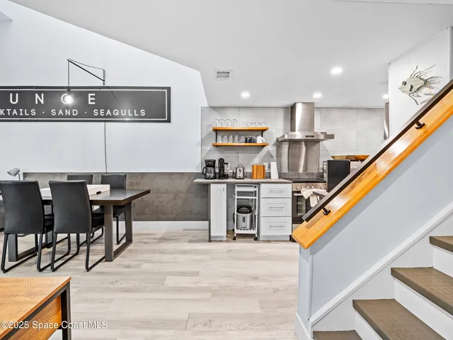 a living room with stainless steel appliances kitchen island granite countertop furniture and a kitchen view