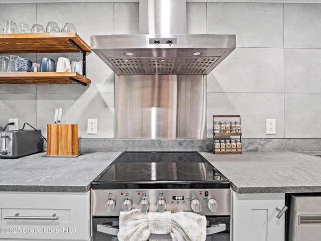 a kitchen with a stove a sink and cabinets