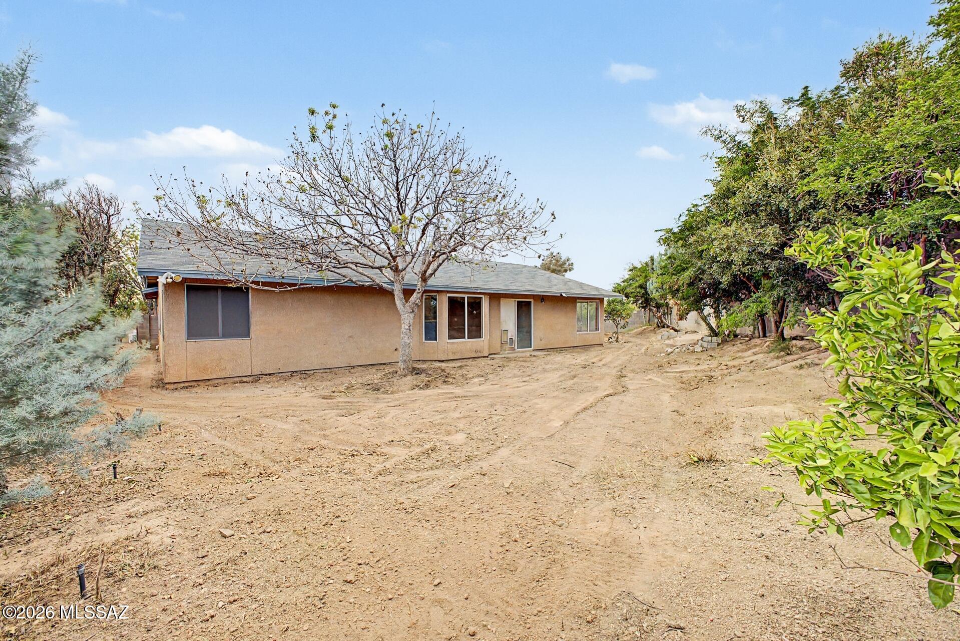 9810 East Stonehaven Way Tucson, AZ 85747 - Photo 7 of 27 a front view of a house with a garden
