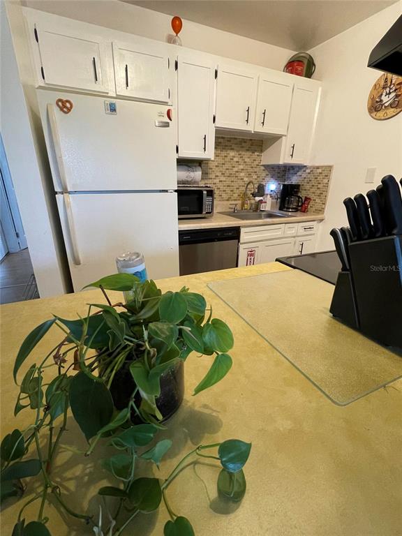 239 South McMullen Booth Road, Unit 38 Clearwater, FL 33759 - Photo 15 of 32 a white kitchen with a refrigerator and a stove