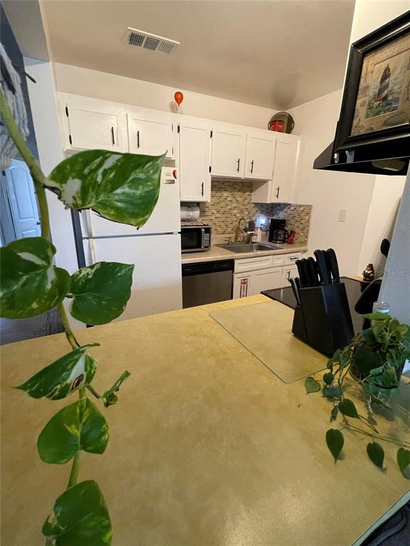 239 South McMullen Booth Road, Unit 38 Clearwater, FL 33759 - Photo 17 of 32 a kitchen with a sink appliances and cabinets