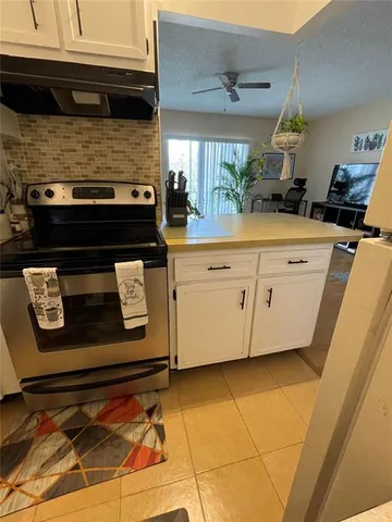 a kitchen with stainless steel appliances granite countertop a sink and a stove