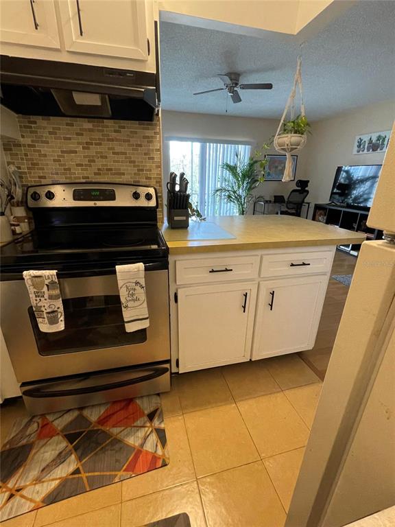 239 South McMullen Booth Road, Unit 38 Clearwater, FL 33759 - Photo 18 of 32 a kitchen with stainless steel appliances granite countertop a sink and a stove