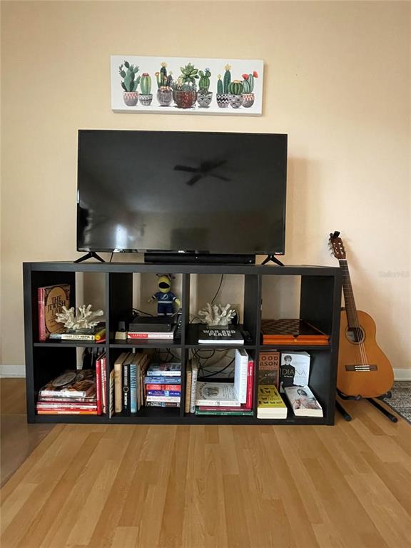 239 South McMullen Booth Road, Unit 38 Clearwater, FL 33759 - Photo 2 of 32 a living room with furniture and a flat screen tv