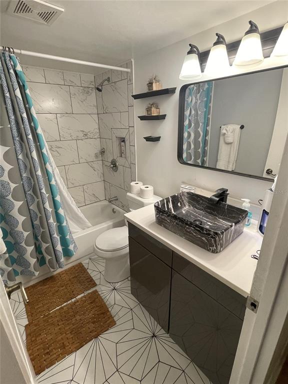 239 South McMullen Booth Road, Unit 38 Clearwater, FL 33759 - Photo 21 of 32 a bathroom with a sink a toilet and shower