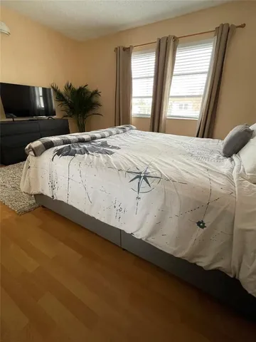a bedroom with a bed and window